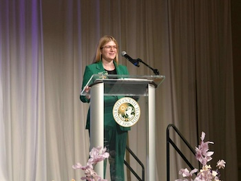 Dr. Nik Lampe delivering a keynote speech at the University of South Florida Lavender Gala, a culturally tailored graduation ceremony for LGBTQ+ and ally students (2025)