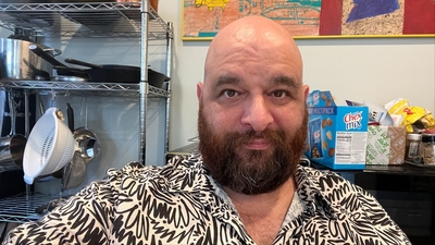 This time the room behind the subject is cluttered with kitchen utensils and food packaging, this feels busy and a little overwhelming